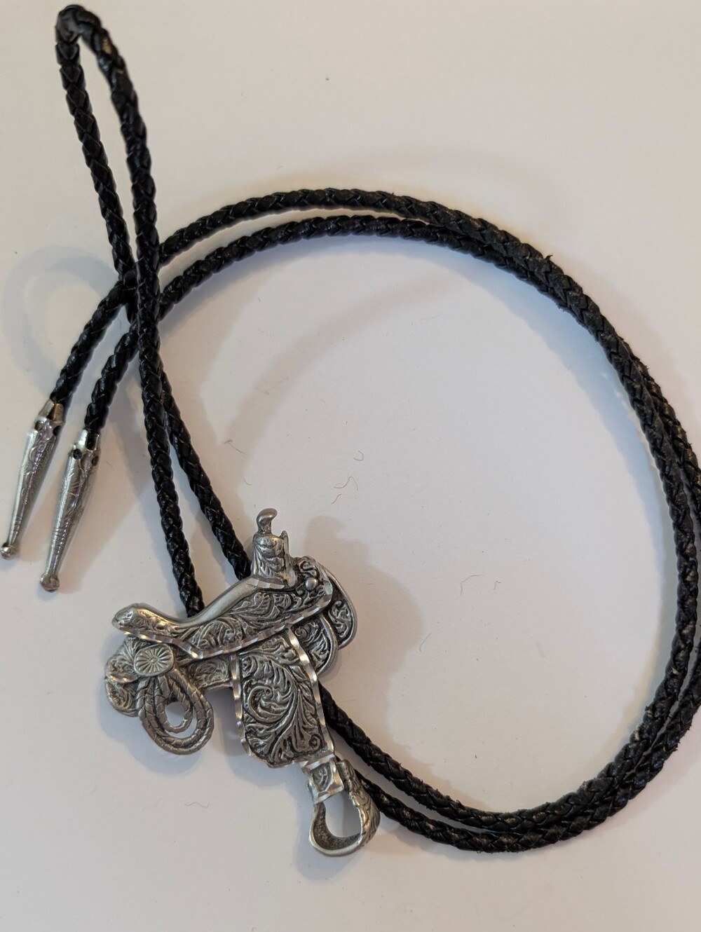 Engraved  Pewter Silver Western Saddle "EGC 91" Black Braided Leather Bolo Tie.